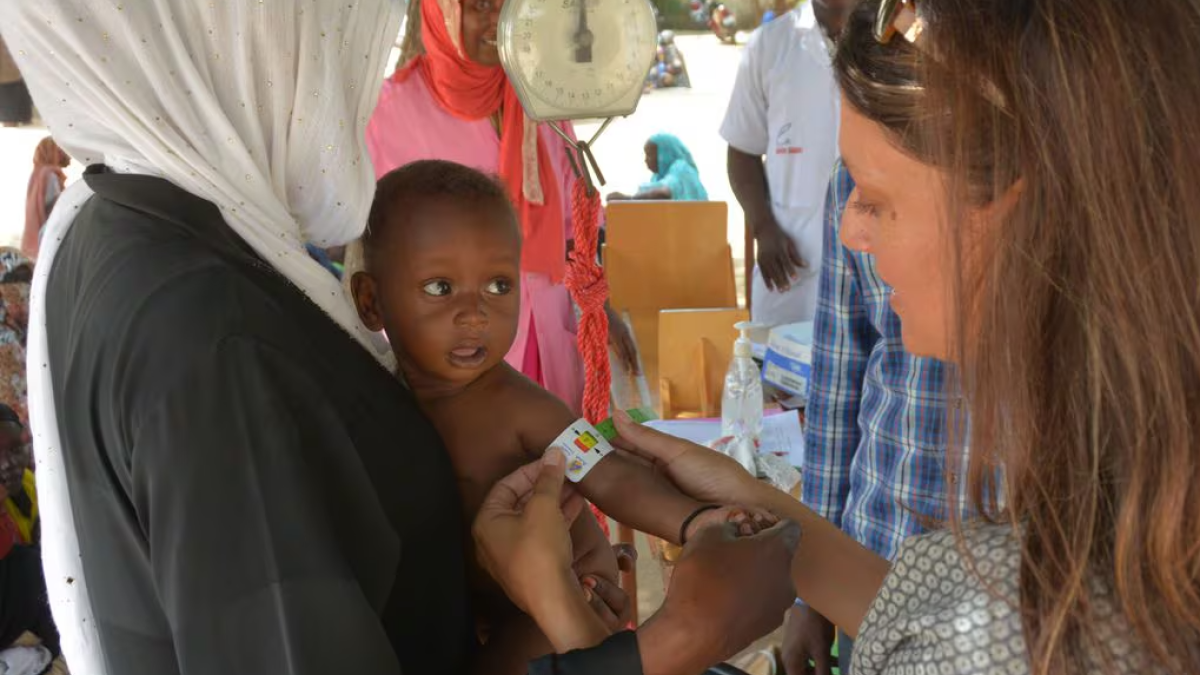 Edesia Nutrition founder and CEO Navyn Salem, right, measures mid-upper arm circumference to gauge the level of malnourishment of a child in Chad in 2018.