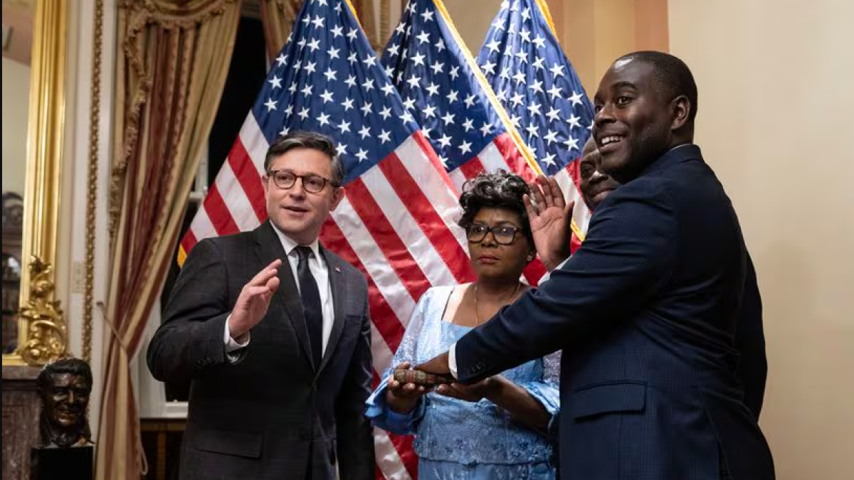 US House Speaker Mike Johnson, left, a Louisiana Republican, participates in a ceremonial swearing-in for new US Representative Gabe Amo., a Rhode Island Democrat, right, at the US Capitol on Monday. Amo is filling the seat formerly held by Representative David N. Cicilline in Rhode Island's First Congressional District. He is joined by his parents, Weady Socree and Gabriel Amo.DREW ANGERER/GETTY
