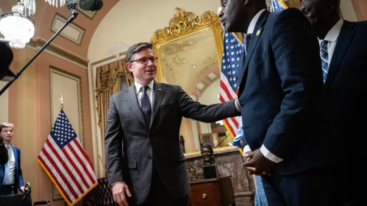 US House Speaker Mike Johnson, left, a Louisiana Republican, participates in a ceremonial swearing-in for new US Representative Gabe Amo., a Rhode Island Democrat, right, at the US Capitol on Monday. Amo is filling the seat formerly held by Representative David N. Cicilline in Rhode Island's First Congressional District. He is joined by his parents, Weady Socree and Gabriel Amo.DREW ANGERER/GETTY