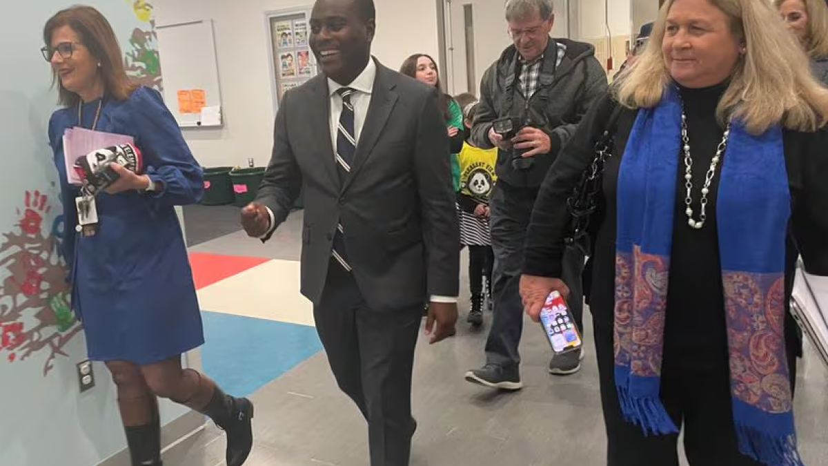 Newly elected US Representative Gabe Amo, a Rhode Island Democrat, tours the Pleasant View Elementary School in Smithfield with Principal Terry Viera, left, and Smithfield public schools Superintendent Dawn Bartz, right.
