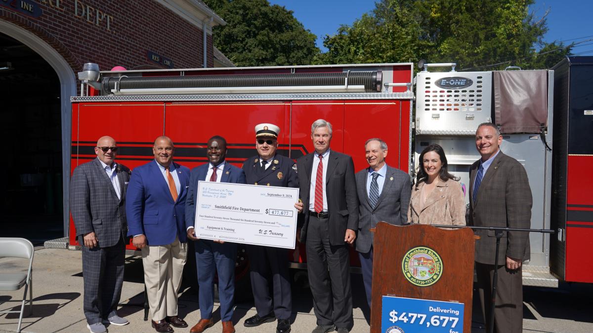 Senator Whitehouse and Congressman Amo present a check to Smithfield Town Manager Randy Rossi, Smithfield Fire Chief Robert Seltzer, and other local leaders