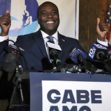 Democrat Gabe Amo gives both thumbs up to the room full of election night supporters, Tuesday, Nov. 7, 2023, at The Guild in Pawtucket, R.I., after winning Rhode Island’s 1st Congressional District seat. The former White House aide will become the state’s first Black candidate elected to the U.S. House. (Kris Craig/Providence Journal via AP)