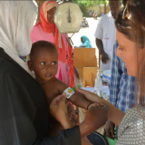 Edesia Nutrition founder and CEO Navyn Salem, right, measures mid-upper arm circumference to gauge the level of malnourishment of a child in Chad in 2018.